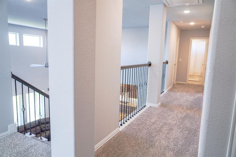 Hallway with carpet flooring and a textured wall
