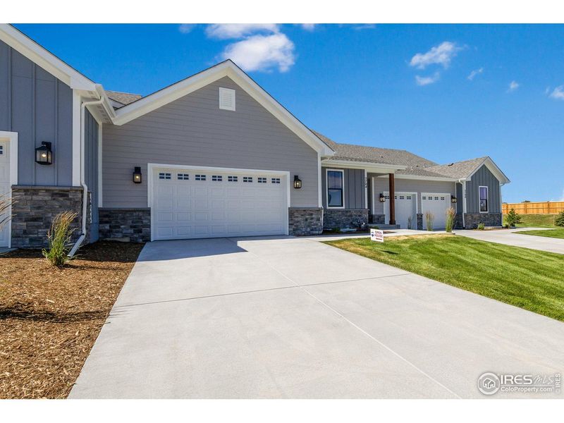 Front exterior of a new home in Cottages at Kelly Farm, Greeley, CO, highlighting curb appeal (Image 26).