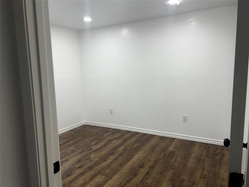 Unfurnished room with hardwood / wood-style floors