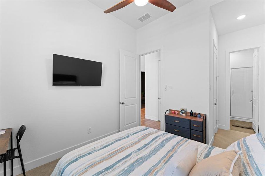 The room features light-colored walls and flooring, with a ceiling fan providing air circulation