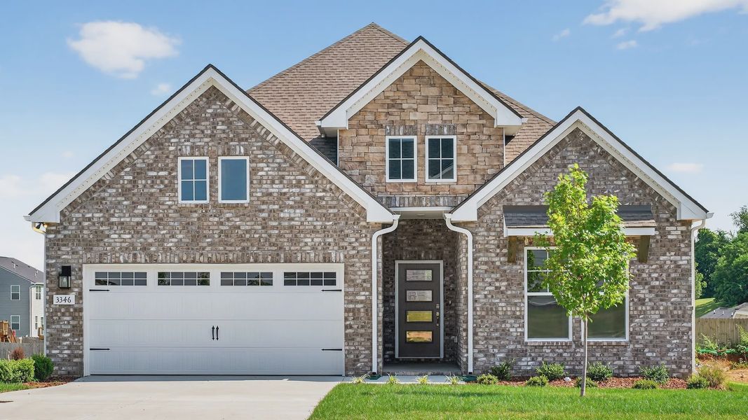 Exquisite brickwork and modern gabled roof design define this Harpeth residence in McClure Farms.