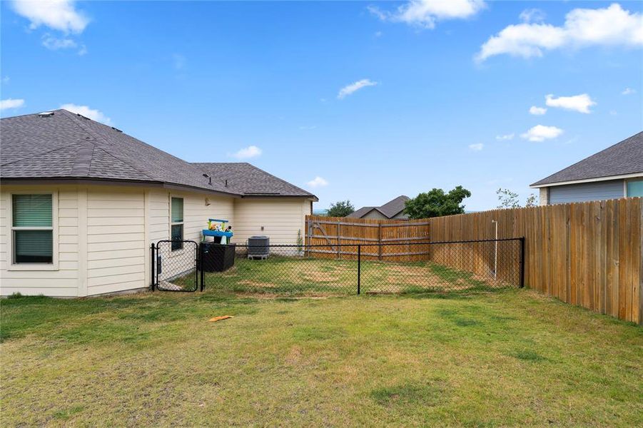 View of fenced backyard