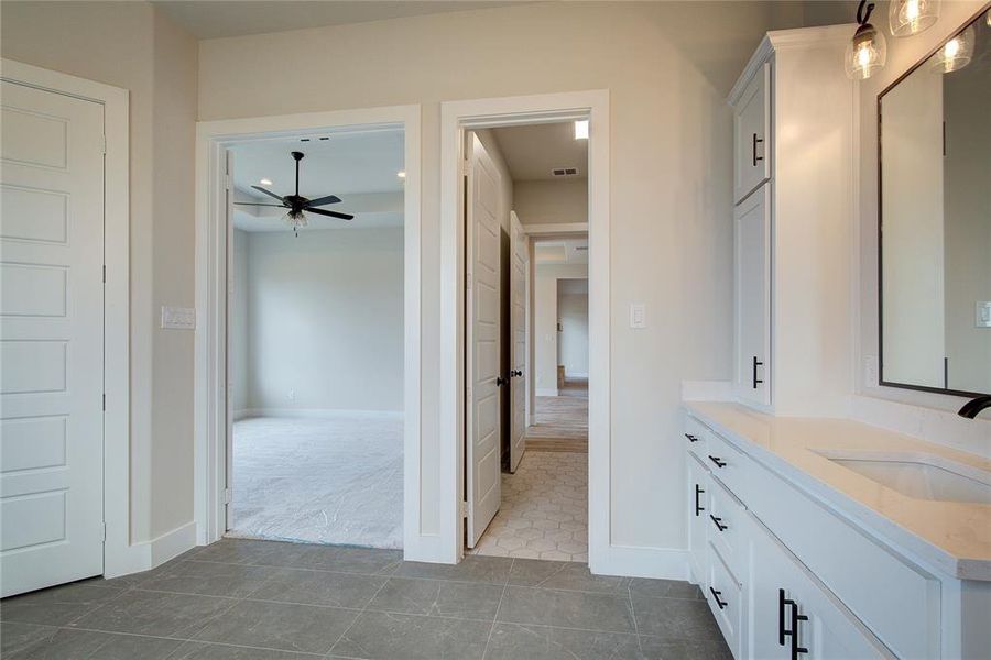 Bathroom featuring ceiling fan, tile flooring, and vanity