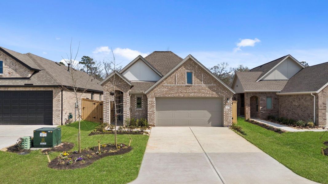 Front exterior of a new home in Grand Central Park, Conroe, TX, highlighting curb appeal (Image 21).