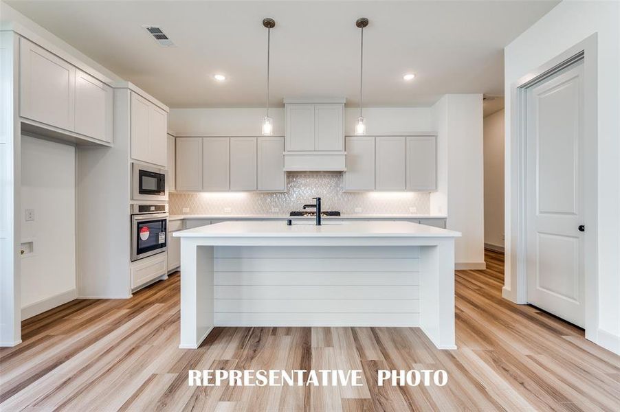 The large kitchen island is the perfect place for a quick family meal or after school homework station.