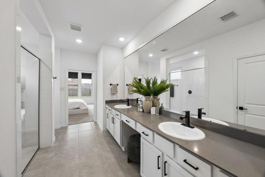 Another view of the primary bath. The mirror features a framed design the owner thoughtfully added. Another view of the primary bath. The mirror features a framed design the owner thoughtfully added.