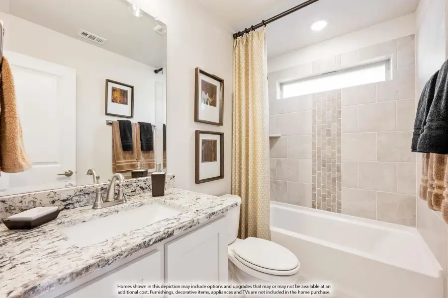 Bathroom with granite countertop vanity, tiled tub-shower combo, and large mirror