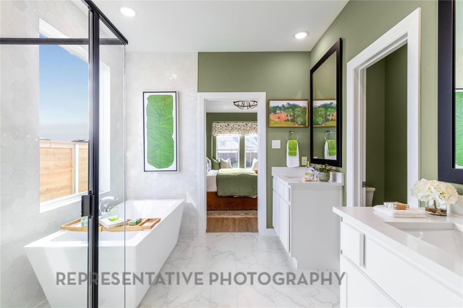 Full bath with vanity, a freestanding bath, marble tiled floors, ensuite bathroom, and recessed lighting