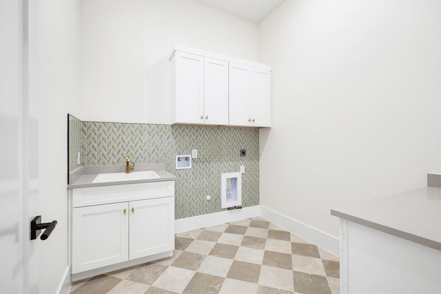Your first laundry room features a deep sink and plenty of storage.