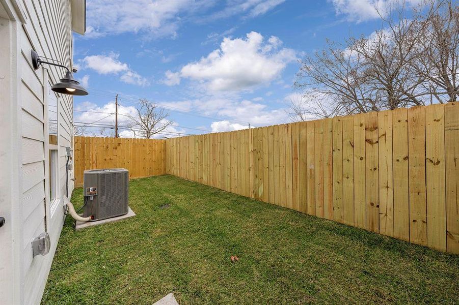 This backyard is completely fenced-in. There’s room for the dog to run around, with plenty of space to lounge, host BBQ, and entertain.