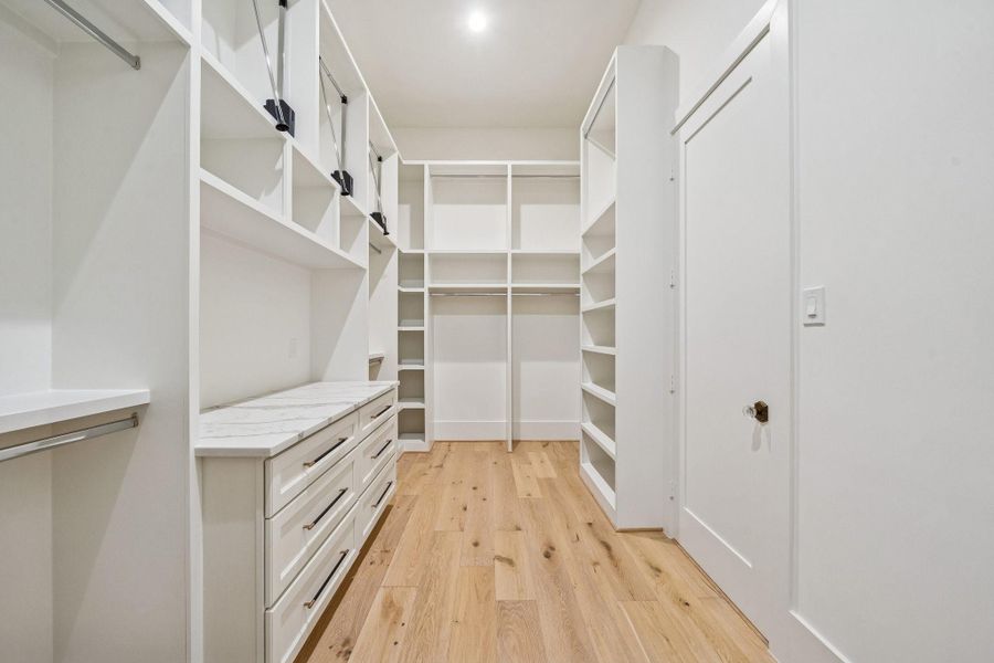 Enough closet space for any fashionista with built-in drawers and upper level pull downs.
