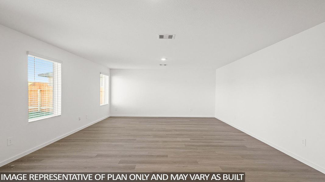 An airy, open-concept interior features wood-look flooring and naturally illuminated walls, ready for personalized design.