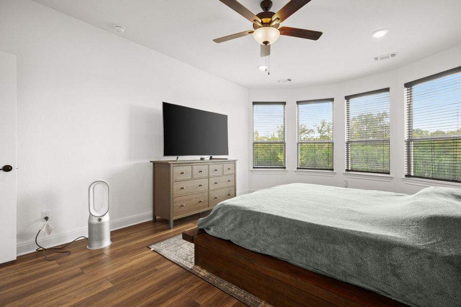Bedroom featuring dark wood-type flooring, ceiling fan, and recessed lighting Bedroom featuring dark wood-type flooring, ceiling fan, and recessed lighting