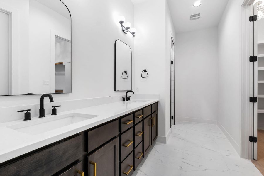 Primary bath with double vanity, light floors, a walk in shower, closet, and recessed lighting Primary bath with double vanity, light floors, a walk in shower, closet, and recessed lighting