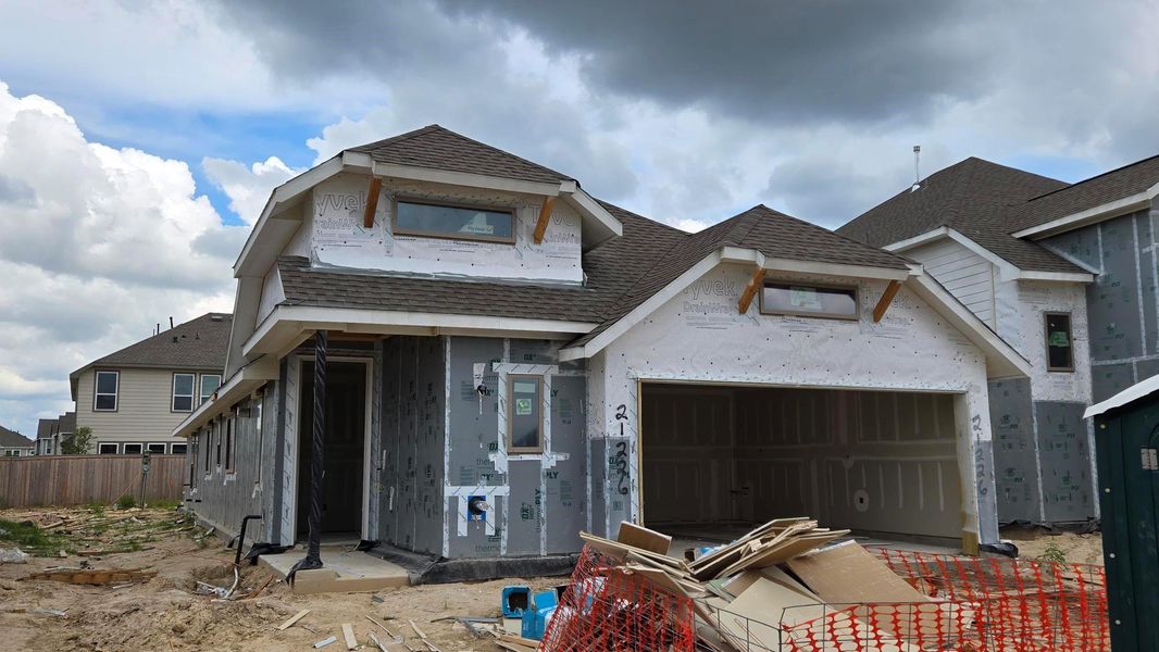 Front exterior of a new home in Bridgeland 40', Cypress, TX, highlighting curb appeal (Image 2). Front exterior of a new home in Bridgeland 40', Cypress, TX, highlighting curb appeal (Image 2).