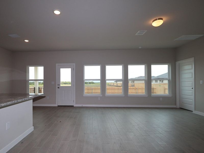 Natural light streams into this generously sized room, highlighting the clean, modern aesthetic.