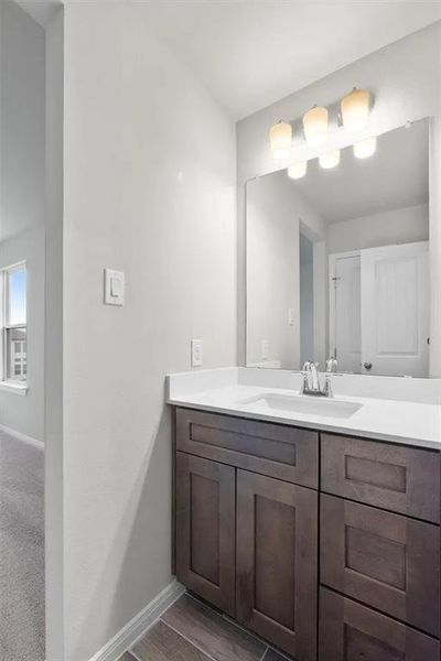 Clean lines define this bathroom with a contemporary vanity and ample mirror space.