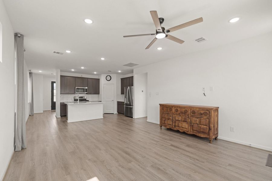 Another view shows just how open concept this kitchen and living room is. So much natural light and space! This light and bright spacious living room is the perfect layout for entertaining or just relaxing!