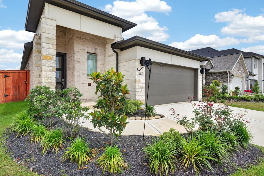 Front exterior of a new home in Jordan Ranch, Fulshear, TX, highlighting curb appeal (Image 27).