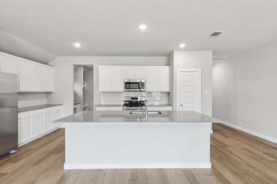 Kitchen in the Heisman home plan by Trophy Signature Homes – REPRESENTATIVE PHOTO Kitchen in the Heisman home plan by Trophy Signature Homes – REPRESENTATIVE PHOTO