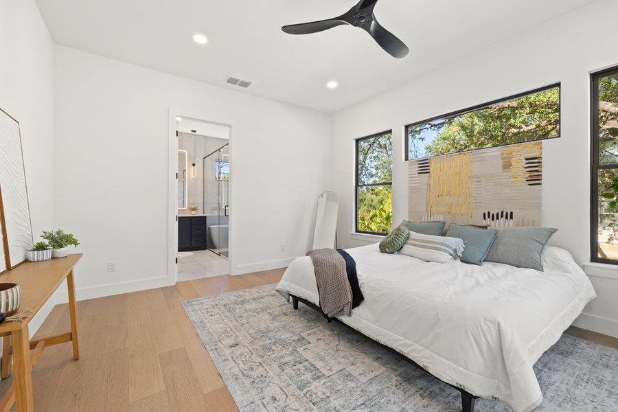 The primary suite offers ample room for a king sized bed, furniture, and a seating area.