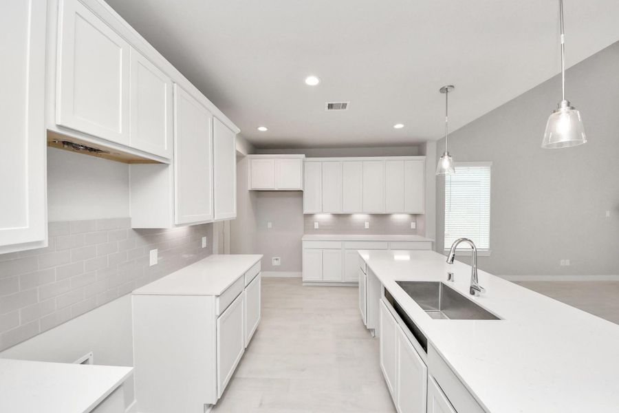 The extended counter area adds both practicality and style, making meal preparation a breeze. Every detail is thoughtfully designed to enhance the kitchen's functionality and aesthetic appeal. Sample photo of completed home with similar floor plan. Actual colors and selections may vary. The extended counter area adds both practicality and style, making meal preparation a breeze. Every detail is thoughtfully designed to enhance the kitchen's functionality and aesthetic appeal. Sample photo of completed home with similar floor plan. Actual colors and selections may vary.