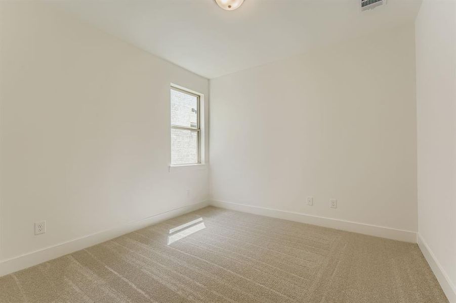 Spare room featuring light carpet and baseboards Spare room featuring light carpet and baseboards