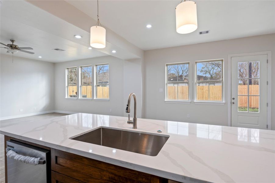 Spacious island with quartz countertop.