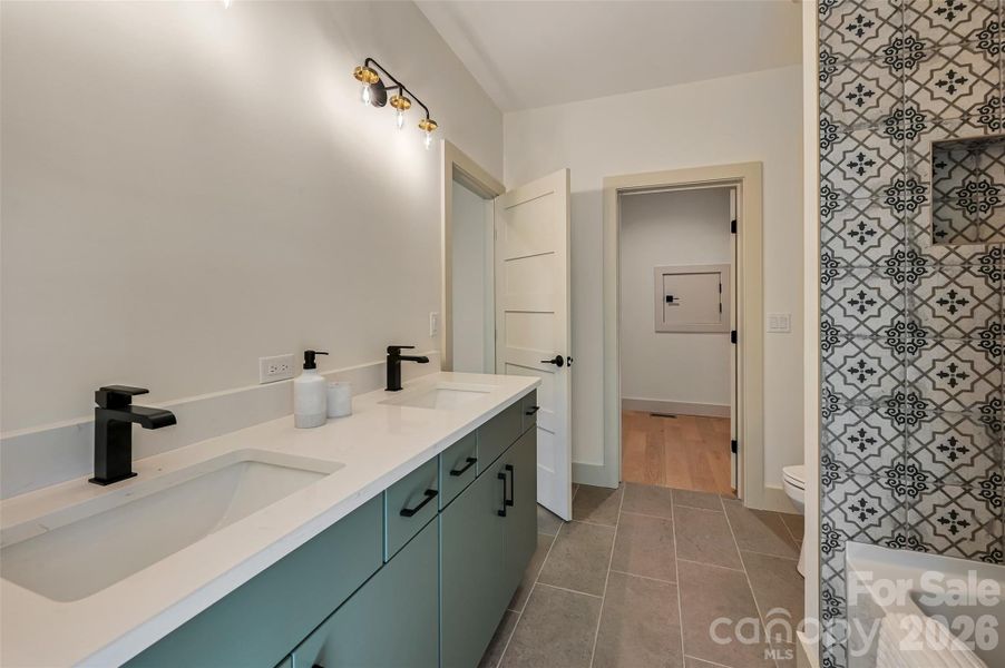 basement full bath with double floating vanity