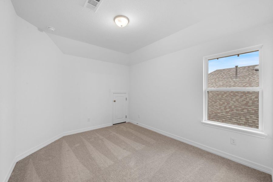 Your secondary bedroom features plush carpet, fresh paint, closet, and a large window that lets in plenty of natural lighting.