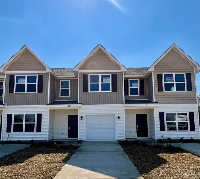 Representative exterior photo of a completed home built from the Plan 1766 Townhome by Adams Homes in Lexlee Estates, Pensacola, FL (Image 1). Representative exterior photo of a completed home built from the Plan 1766 Townhome by Adams Homes in Lexlee Estates, Pensacola, FL (Image 1).