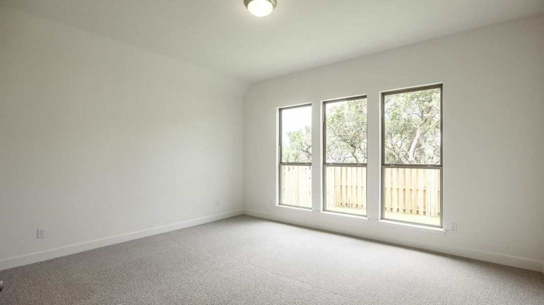Carpeted empty room featuring baseboards Carpeted empty room featuring baseboards