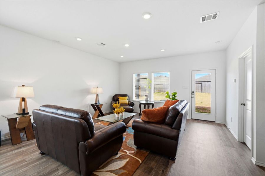 Open living space flowing to a shaded covered patio, ideal for year-round indoor-outdoor living.