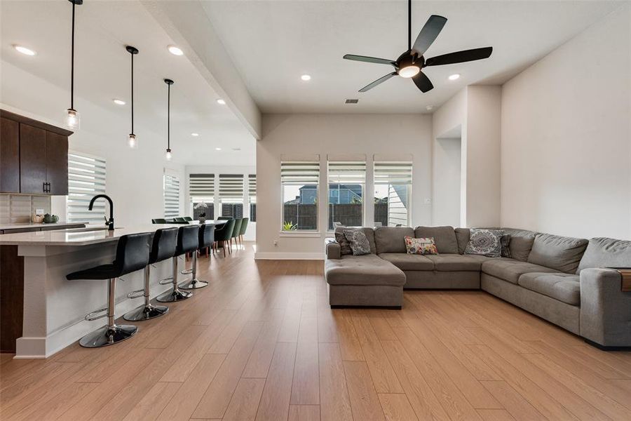 Living area featuring recessed lighting, light wood-style floors, and ceiling fan