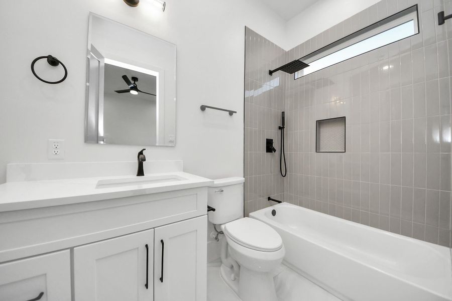 Ample storage and a 30-inch vanity are complemented by a gorgeous shower, perfect for unwinding. A window allows natural light to fill the space, while a built-in nook and rainfall showerhead enhance the experience. Ample storage and a 30-inch vanity are complemented by a gorgeous shower, perfect for unwinding. A window allows natural light to fill the space, while a built-in nook and rainfall showerhead enhance the experience.