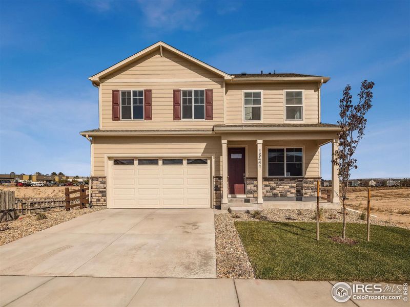 Front exterior of a new home in Tailholt, Severance, CO, highlighting curb appeal (Image 1). Front exterior of a new home in Tailholt, Severance, CO, highlighting curb appeal (Image 1).