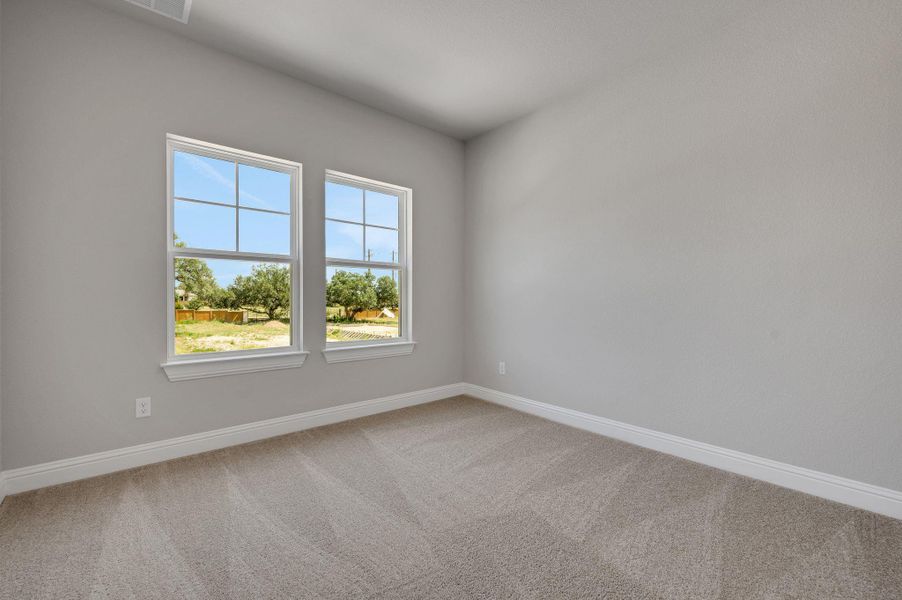 Unfurnished room featuring carpet floors and baseboards