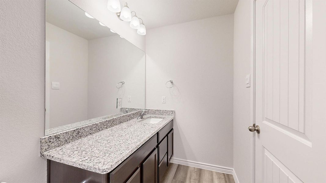 Bathroom featuring vanity and light wood finished floors