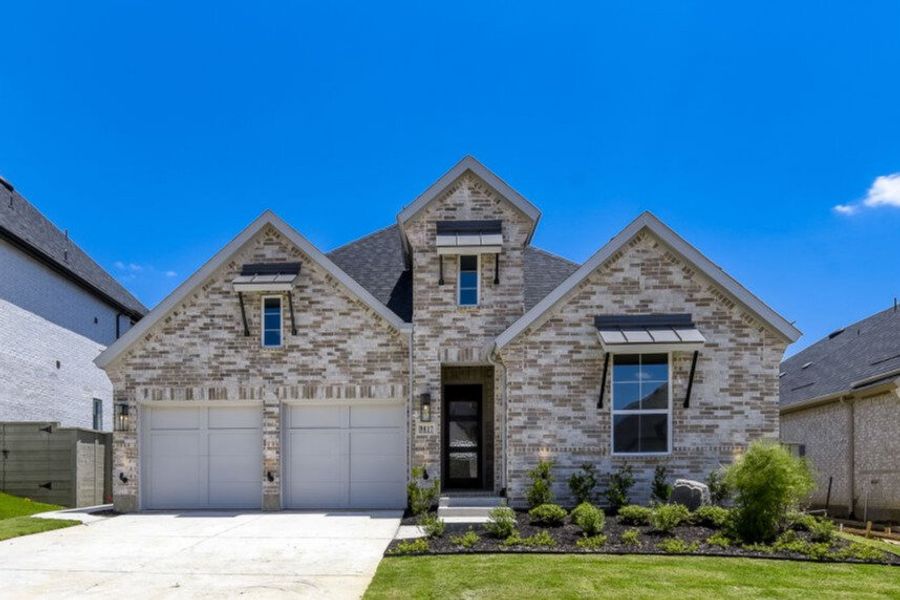 Front exterior of a new home in Landmark, Denton, TX, highlighting curb appeal (Image 1). Front exterior of a new home in Landmark, Denton, TX, highlighting curb appeal (Image 1).