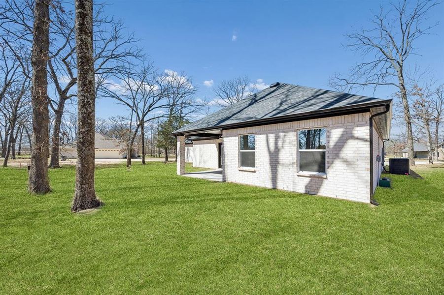 View of back of the house and treed yard.