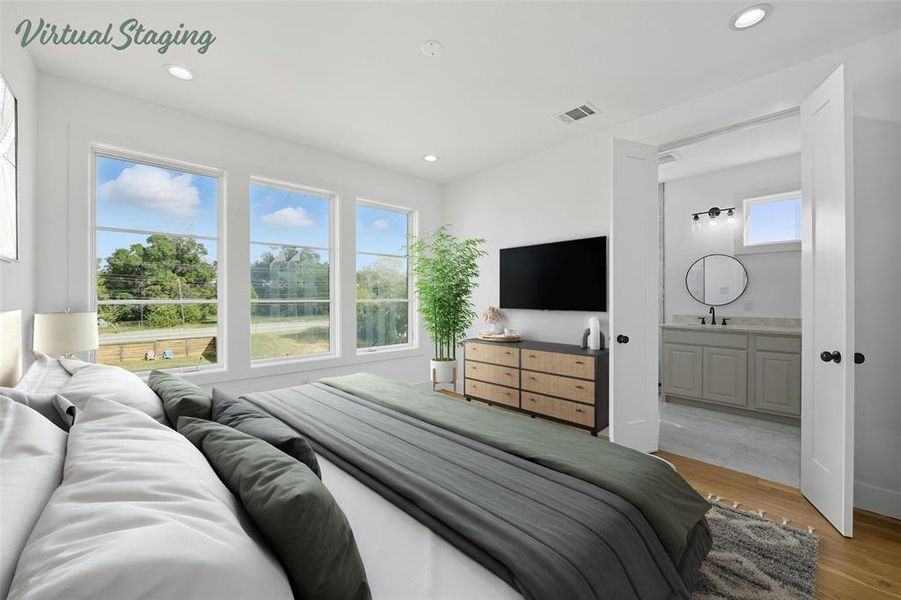 Bedroom with light wood-style flooring, recessed lighting, and ensuite bath