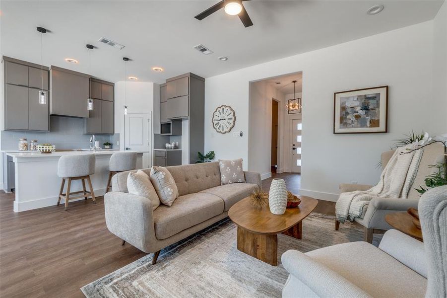 Living room featuring ceiling fan, sink, and hardwood / wood-style flooring