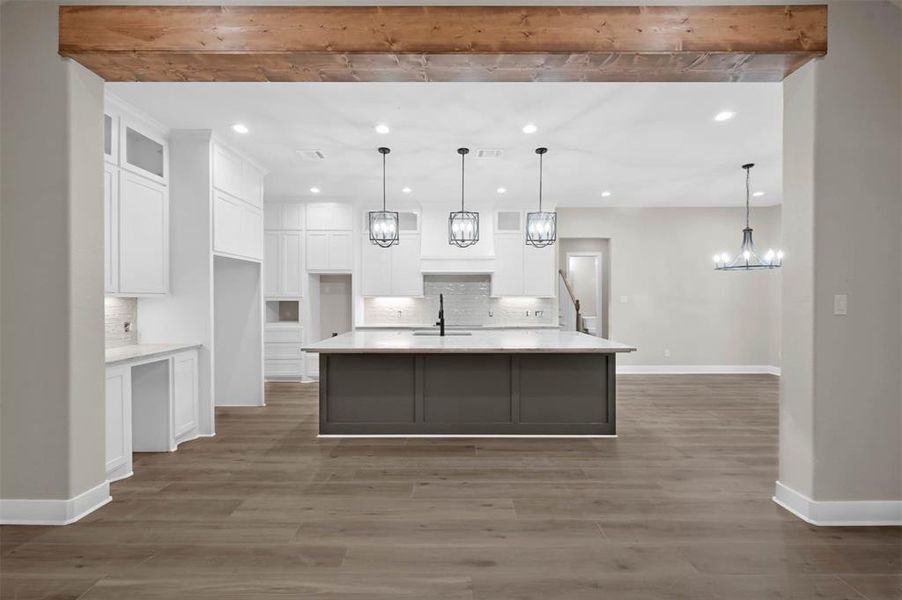 A view of your kitchen with custom cabinets, quartz counter tops and an island for a chef!