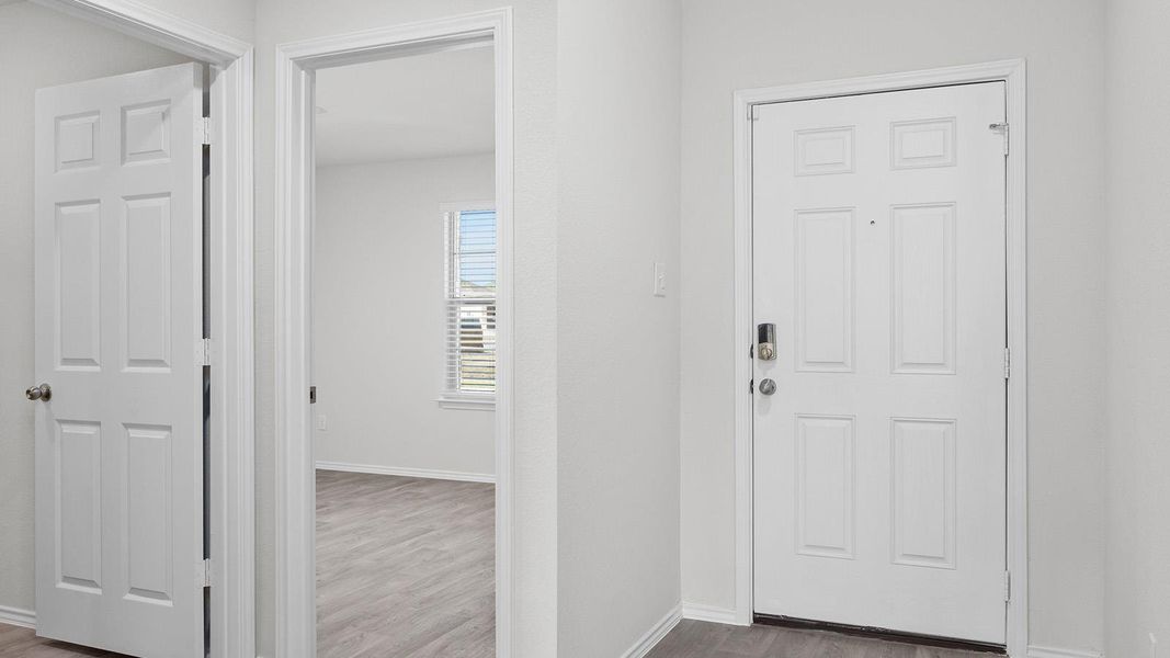 Foyer entrance featuring wood finished floors and baseboards