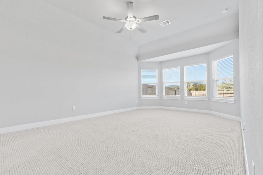Primary bedroom with bay windows on first floor. Primary bedroom with bay windows on first floor.