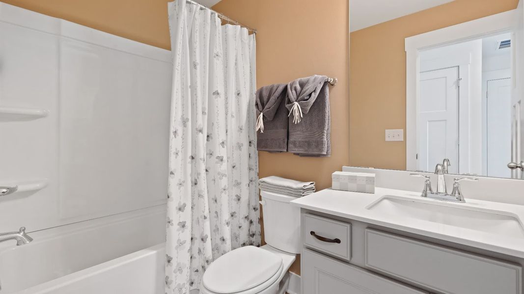 Elegant bath retreat of The Churchill Design with designer finishes and a clean, timeless aesthetic