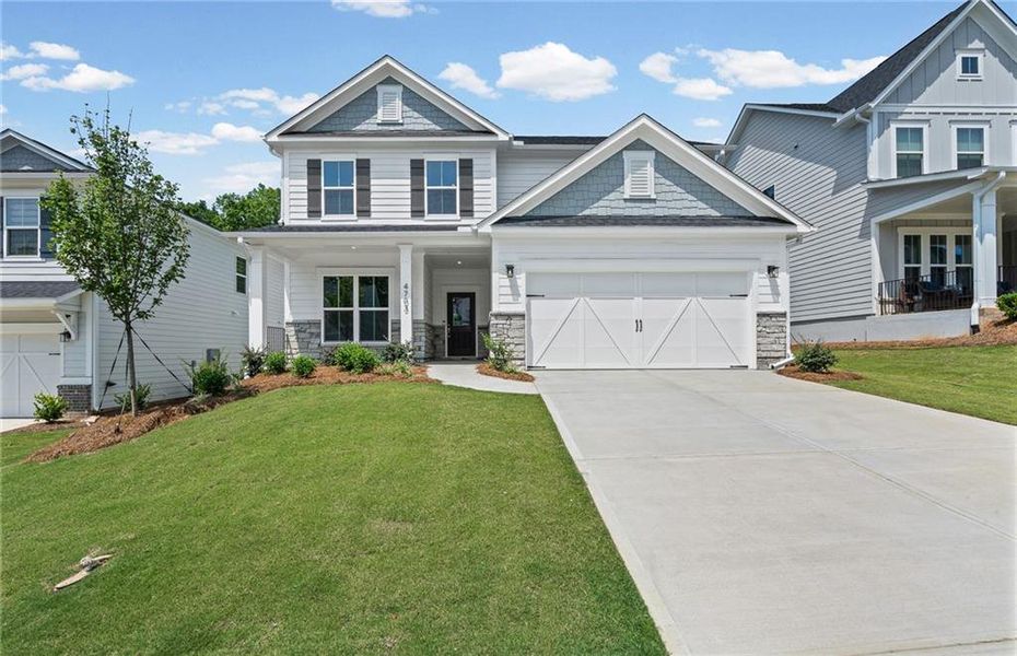 Front exterior of a new home in Hunters Creek, Flowery Branch, GA, highlighting curb appeal (Image 2). Front exterior of a new home in Hunters Creek, Flowery Branch, GA, highlighting curb appeal (Image 2).