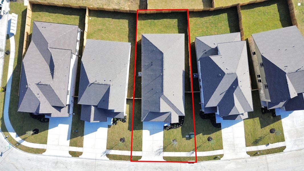 An aerial view of a spacious subdivision lot, highlighting a well-maintained yard and a fully fenced perimeter, offering both privacy andexpansive outdoor space.