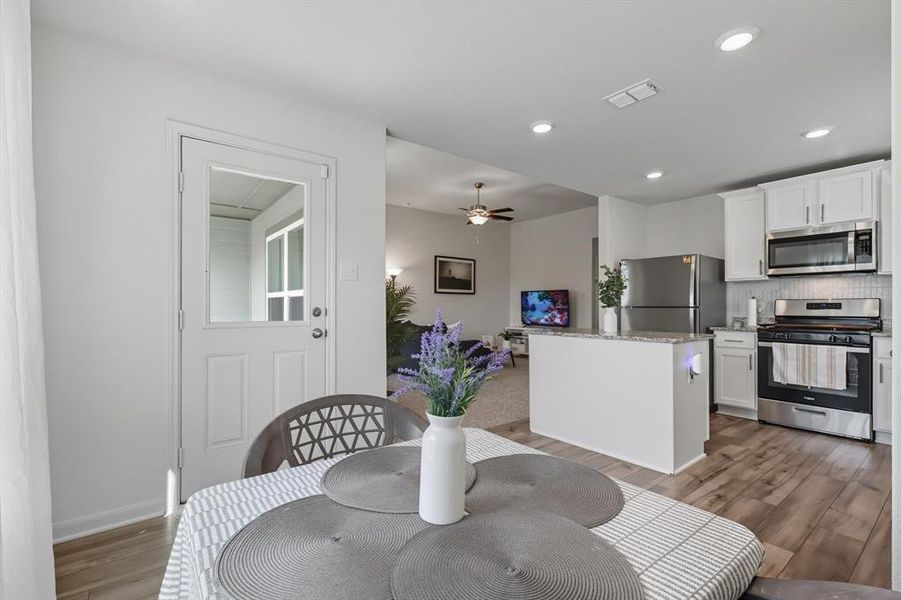 Dining space featuring light wood-style flooring, a ceiling fan, and recessed lighting