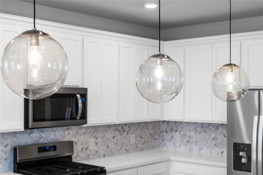 Atwell Pendant Brushed Nickel lights that hang over the kitchen counter.